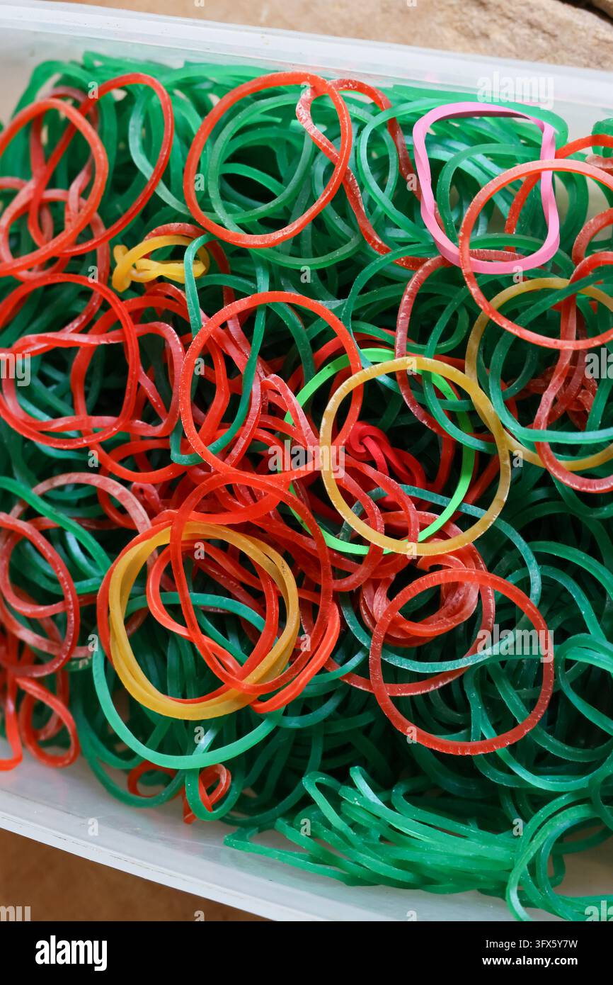 A colorful rubber band collection in red, green, pink, and yellow ...