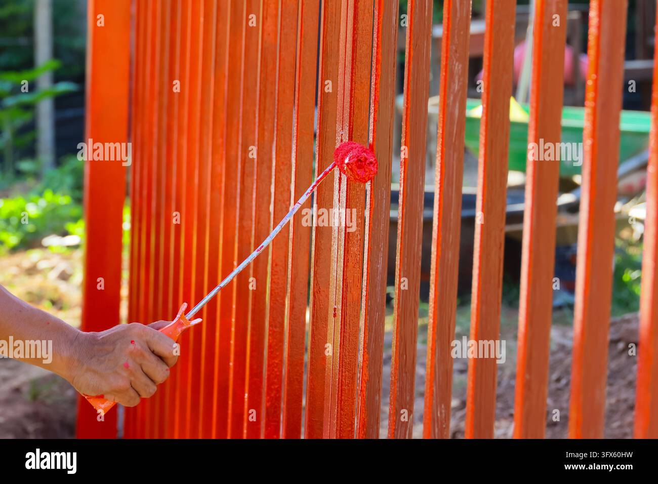 Use Hand Railing Signs An orange metal railing construction detail with hand holding red paint ...