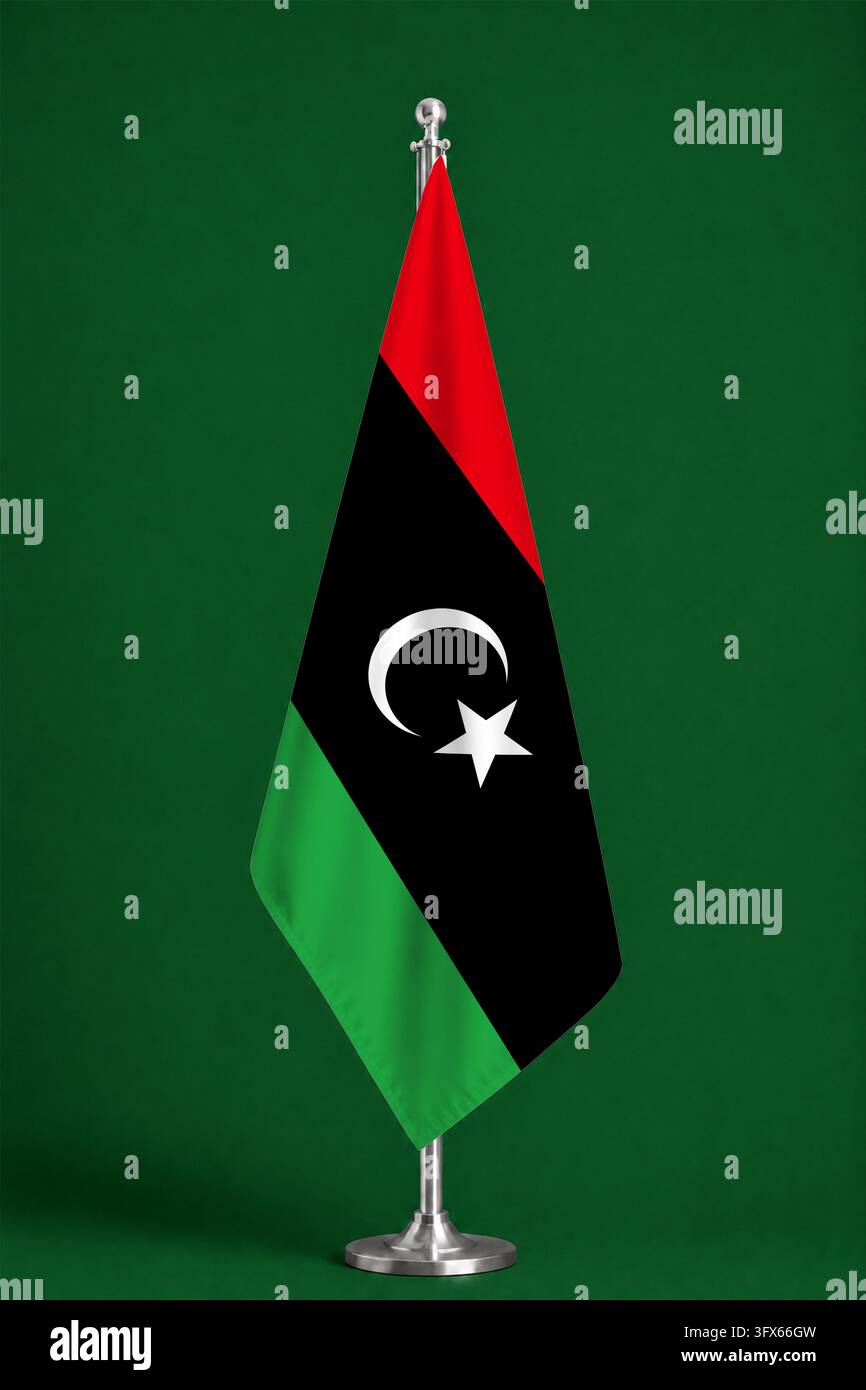3D illustration. Flag of Libya on a ceremonial standing flag on a pole ...