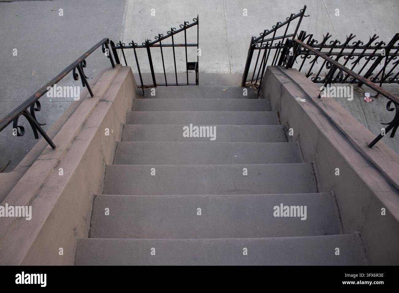 Stone stairs from below with fence Stock Photo