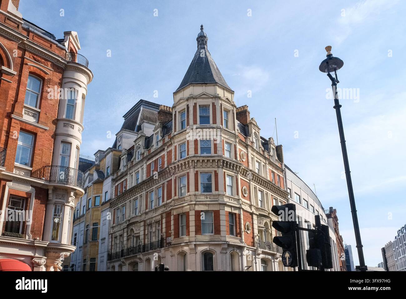 Historic red brick and stone corner building with a pointed turret ...