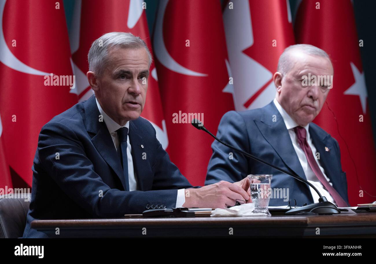Turkish President Recep Tayyip Erdogan, right, looks on as Prime ...