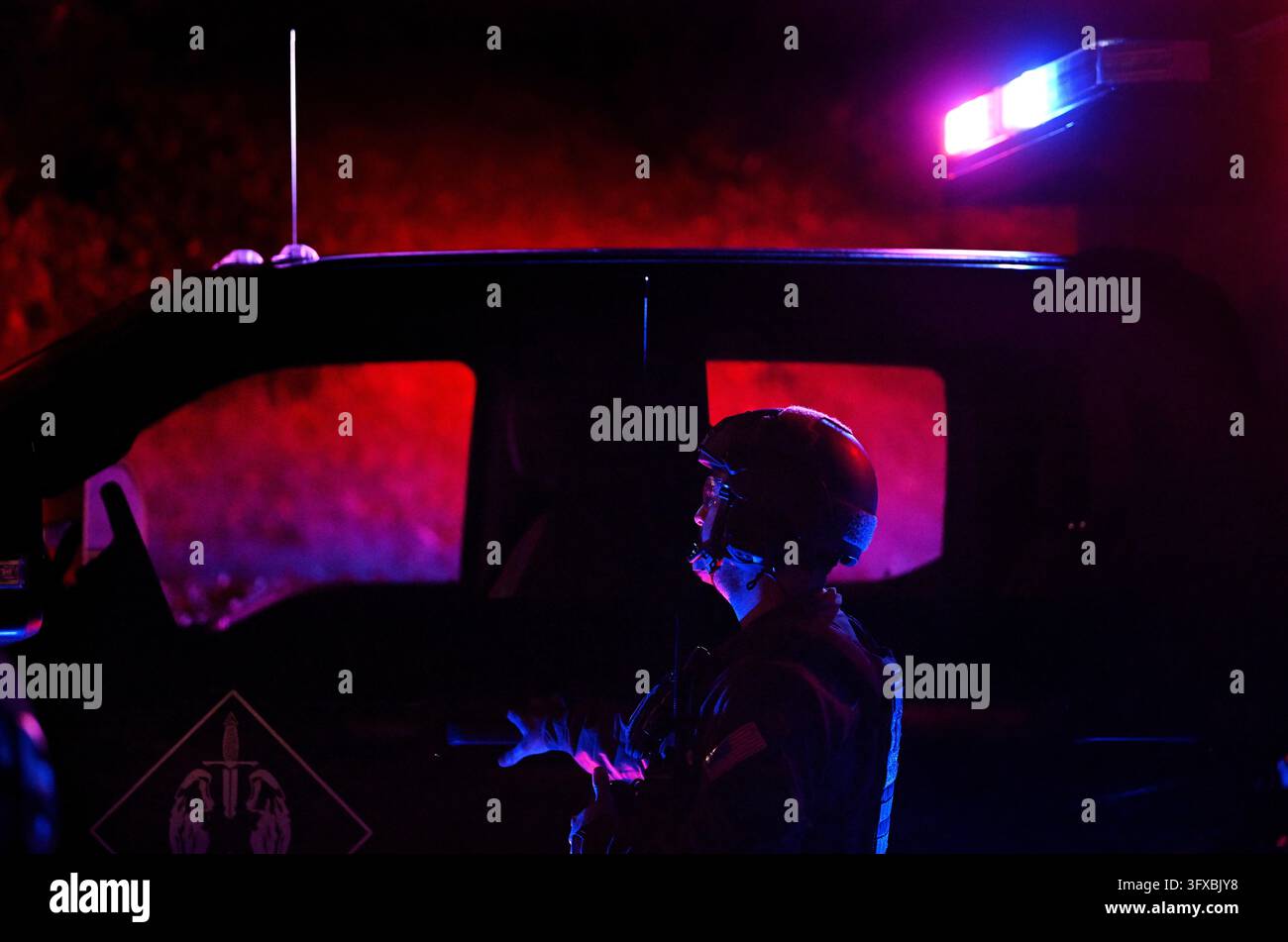 Federal agents arrive to a suspect's house during a raid related to ...