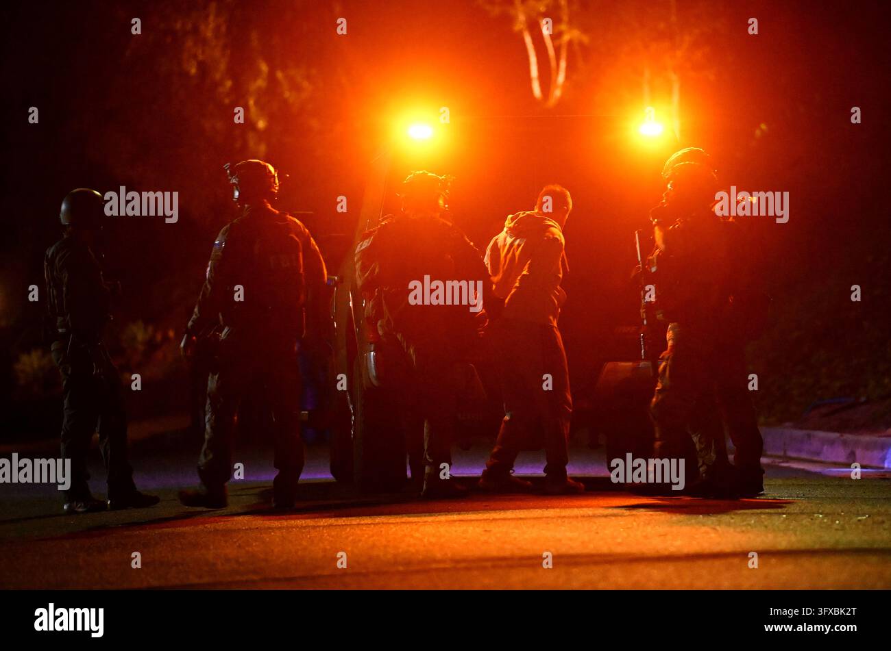 Federal agents arrest a suspect during a raid related to health care ...