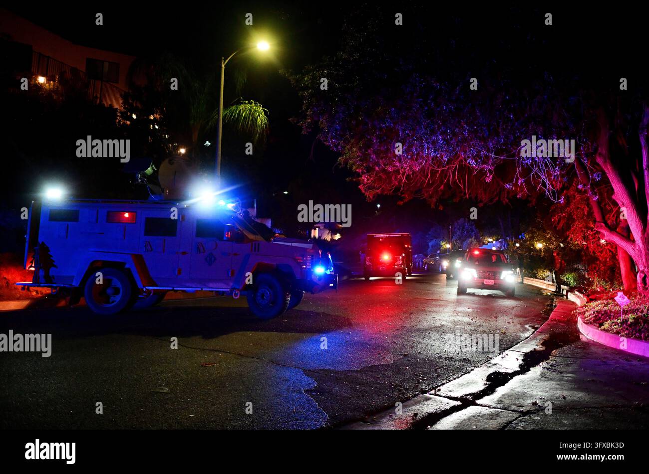 Federal agents arrive to a suspect's house during a raid related to ...