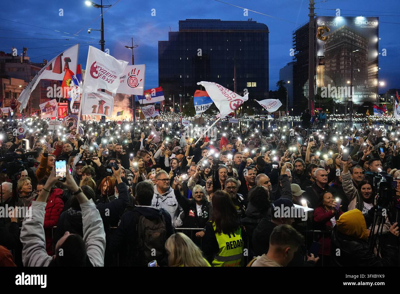 People flash the lights of their mobile phones during the final ...