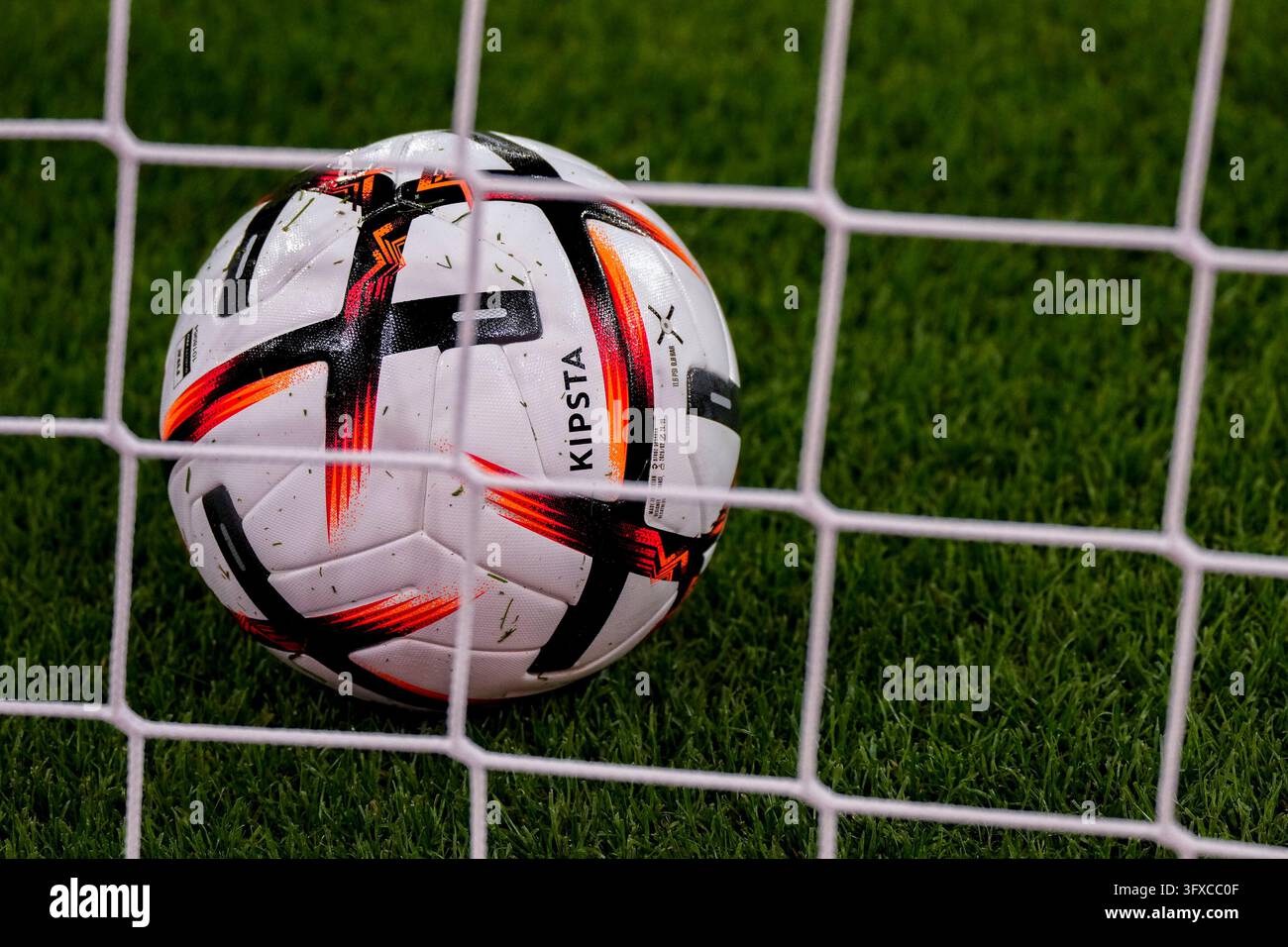 A ball of the brand KIPSTA Decathlon Official Match Football is behind ...