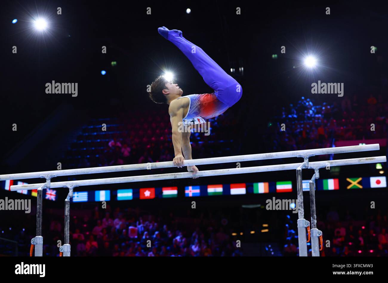 Oka Shinnosuke of Japan competes on the parallel bars in the men's all ...