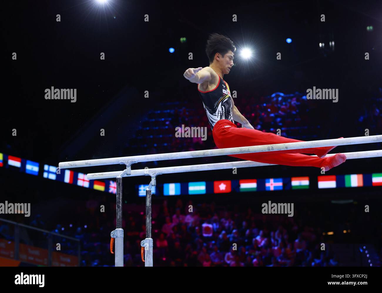 Hashimoto Daiki of Japan competes on the parallel bars in the men's all ...