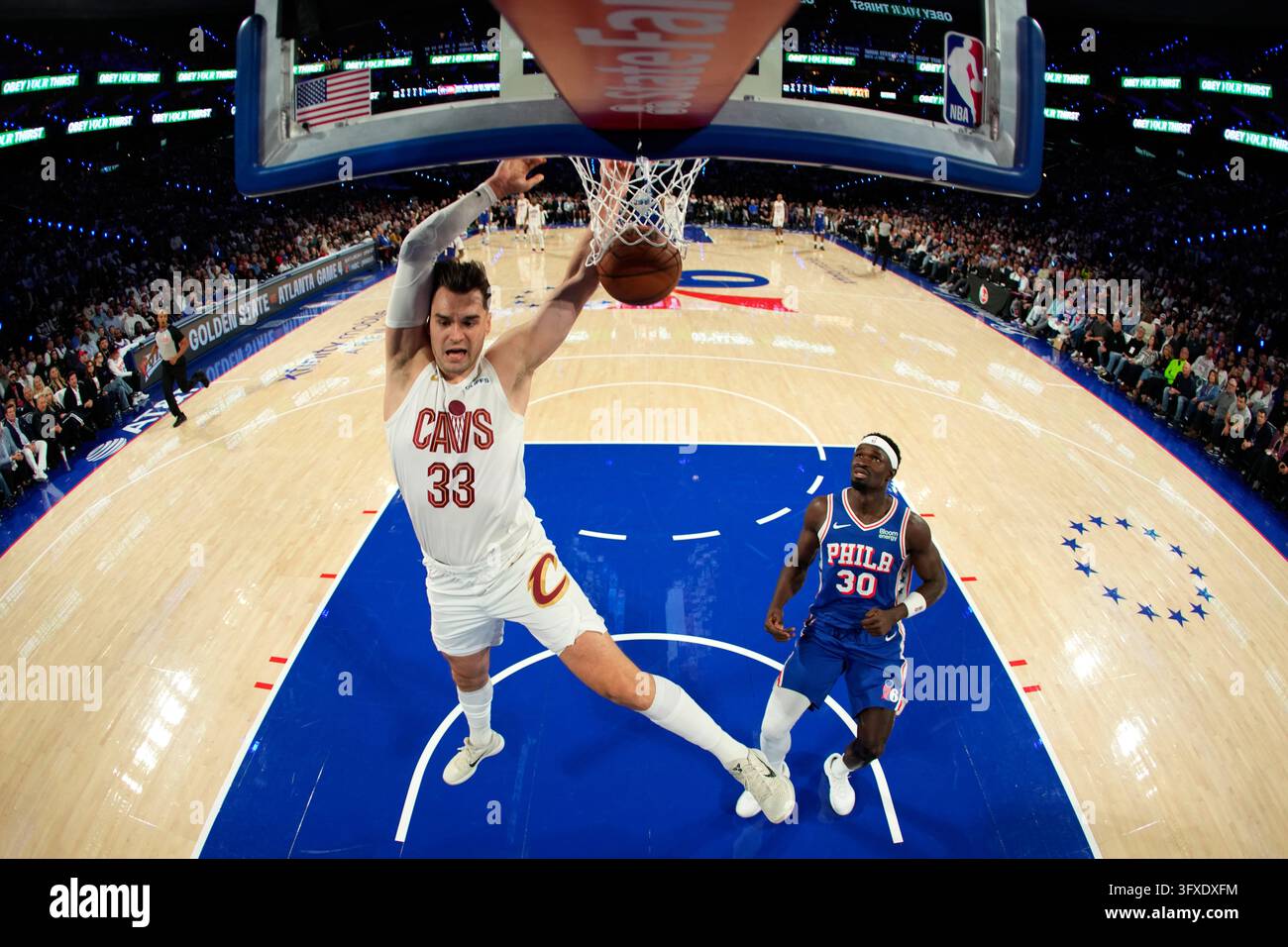 Mario Thursday Cleveland Cavaliers' Mario Hezonja, left, dunks past Philadelphia 76ers ...
