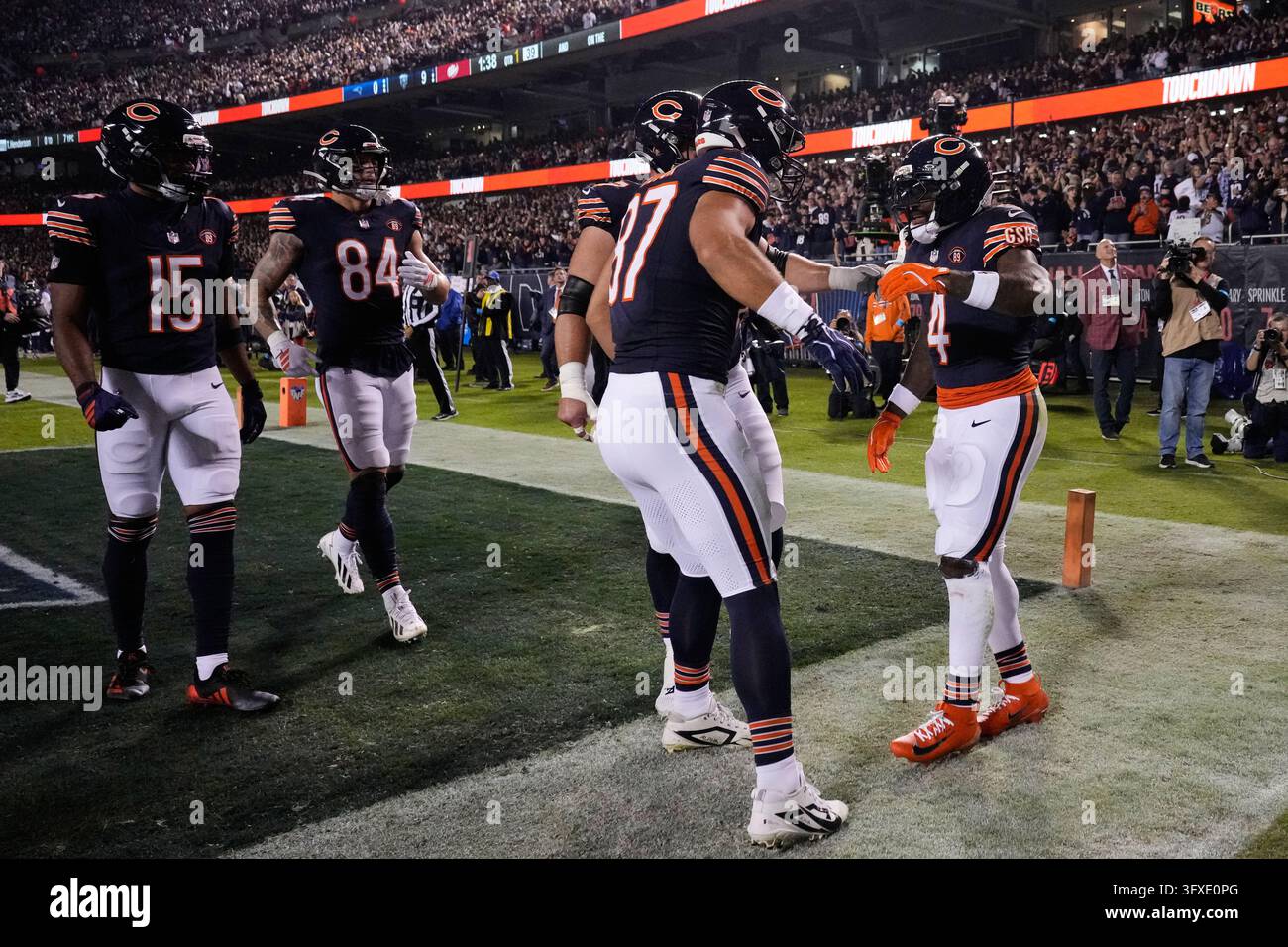 Chicago Bears' D'Andre Swift (4), Sam Roush, second from right, and ...