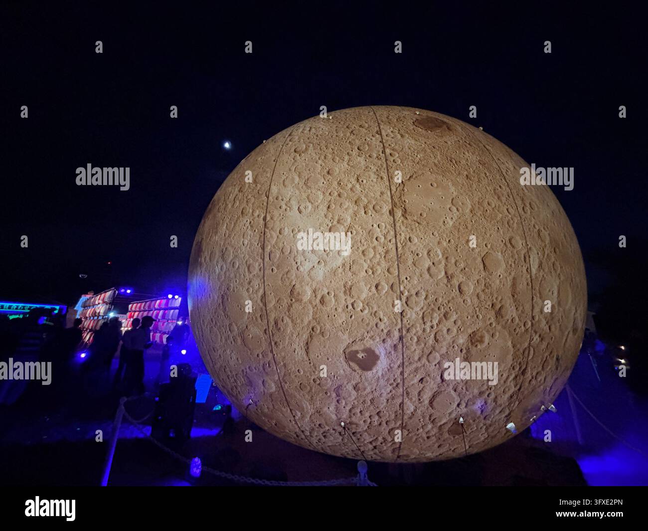 Different angle view of a glowing moon art installation displayed at a limited-time festive event held in Maizuru Park, Fukuoka, Japan. - Smartphone Captured Stock Image
