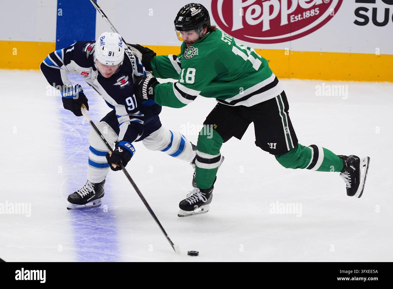 Winnipeg Jets center Cole Perfetti (91) reaches for the puck against ...