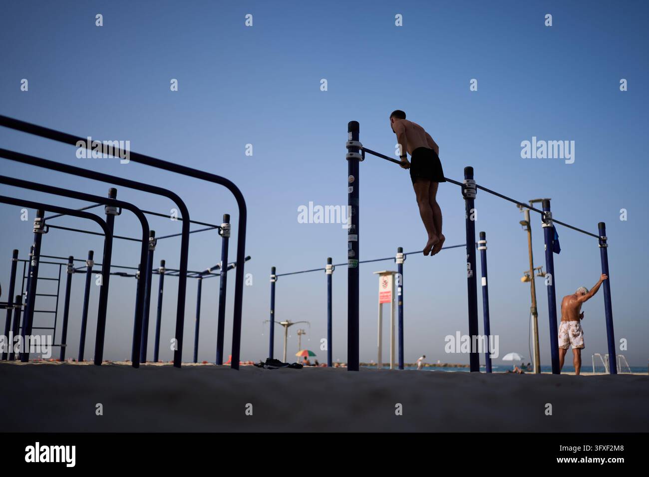 A person works out on a pull-up bar at a beachfront gym, Friday, Oct ...