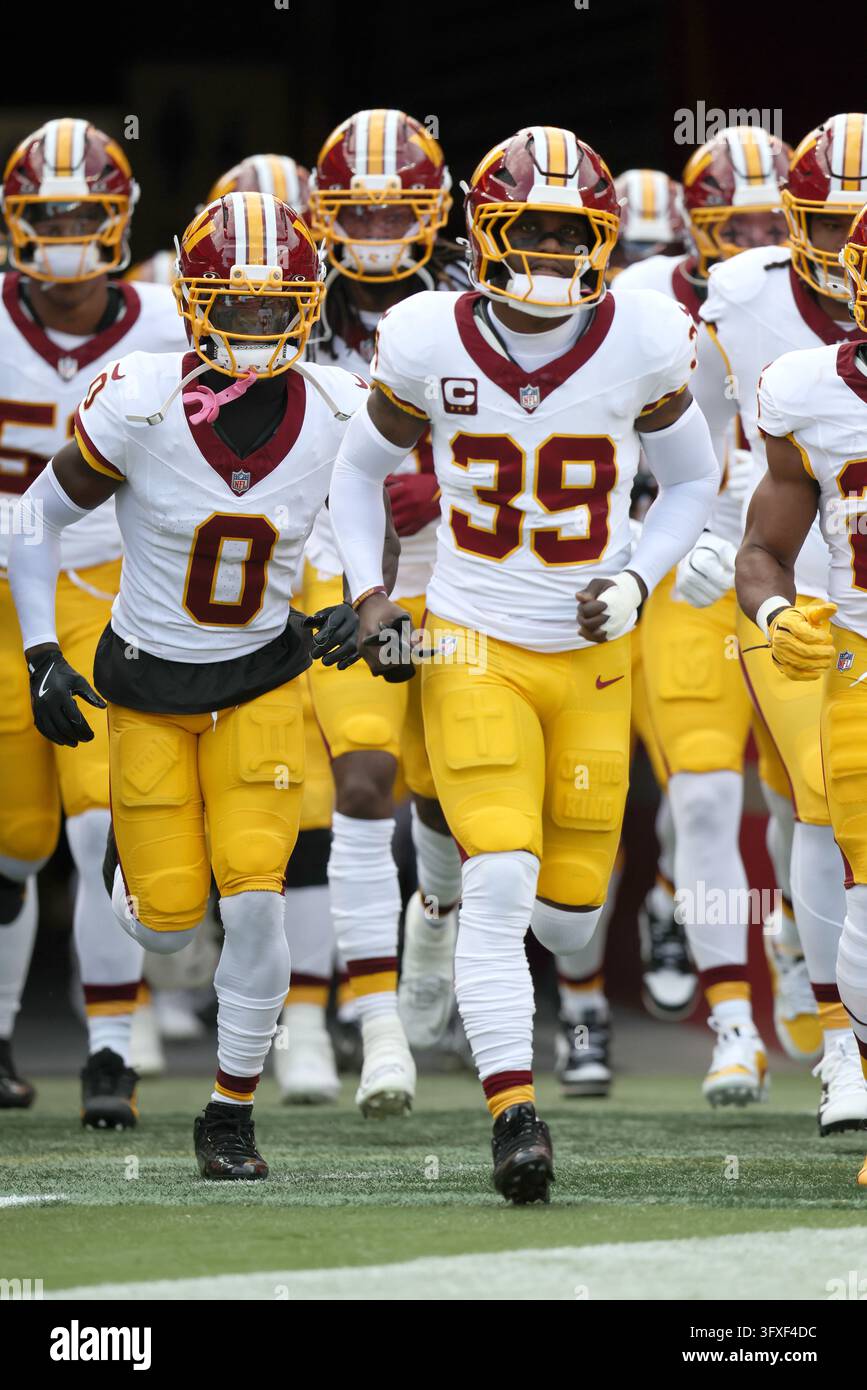 Washington Commanders safety Jeremy Reaves (39) leads the team out onto ...