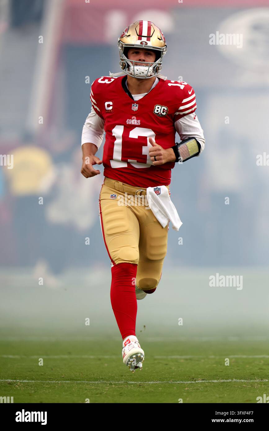 San Francisco 49ers quarterback Brock Purdy (13) runs onto the field ...