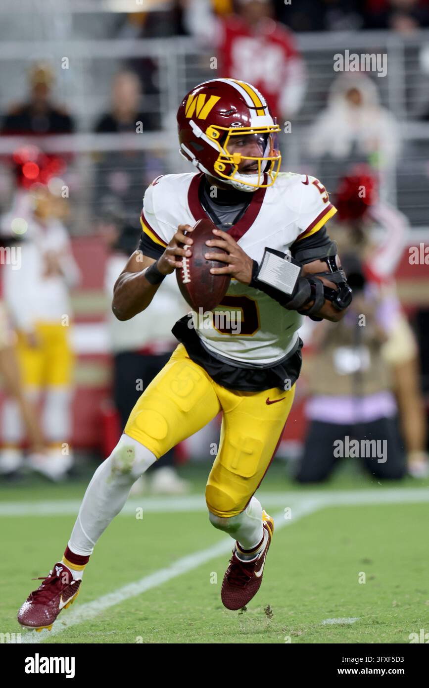 Washington Commanders quarterback Jayden Daniels (5) runs during an NFL ...