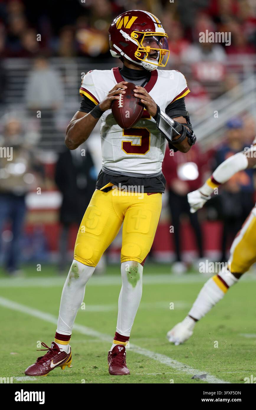 Washington Commanders quarterback Jayden Daniels (5) runs during an NFL ...