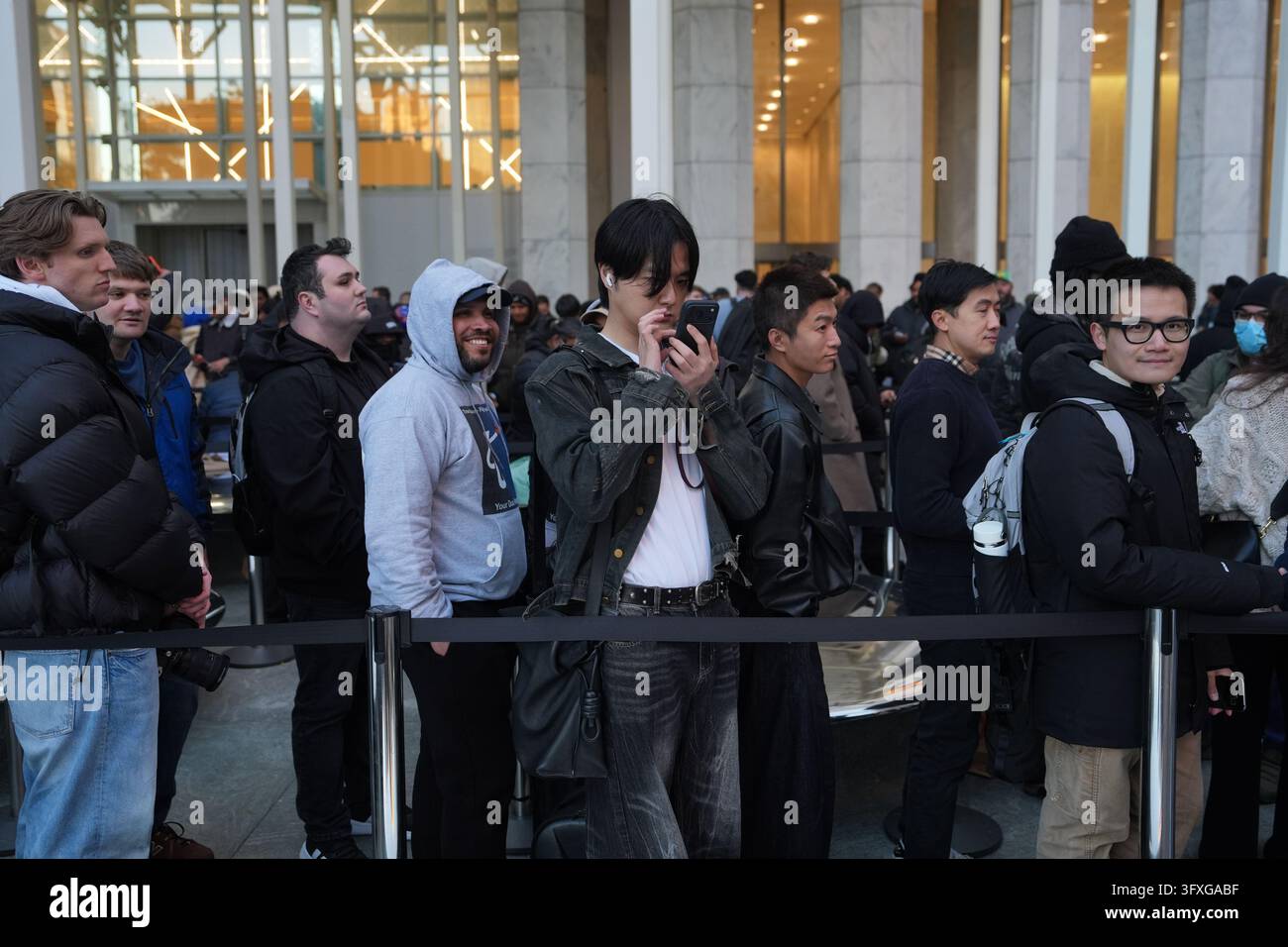 People line up outside to buy the newly-launched iPhone Duo at the ...
