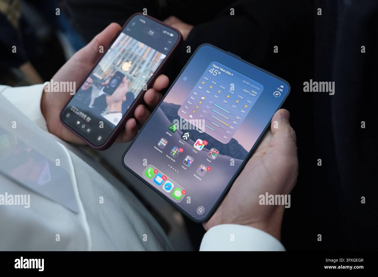A staff member holds the newly-launched iPhone Duo, right, outside the ...
