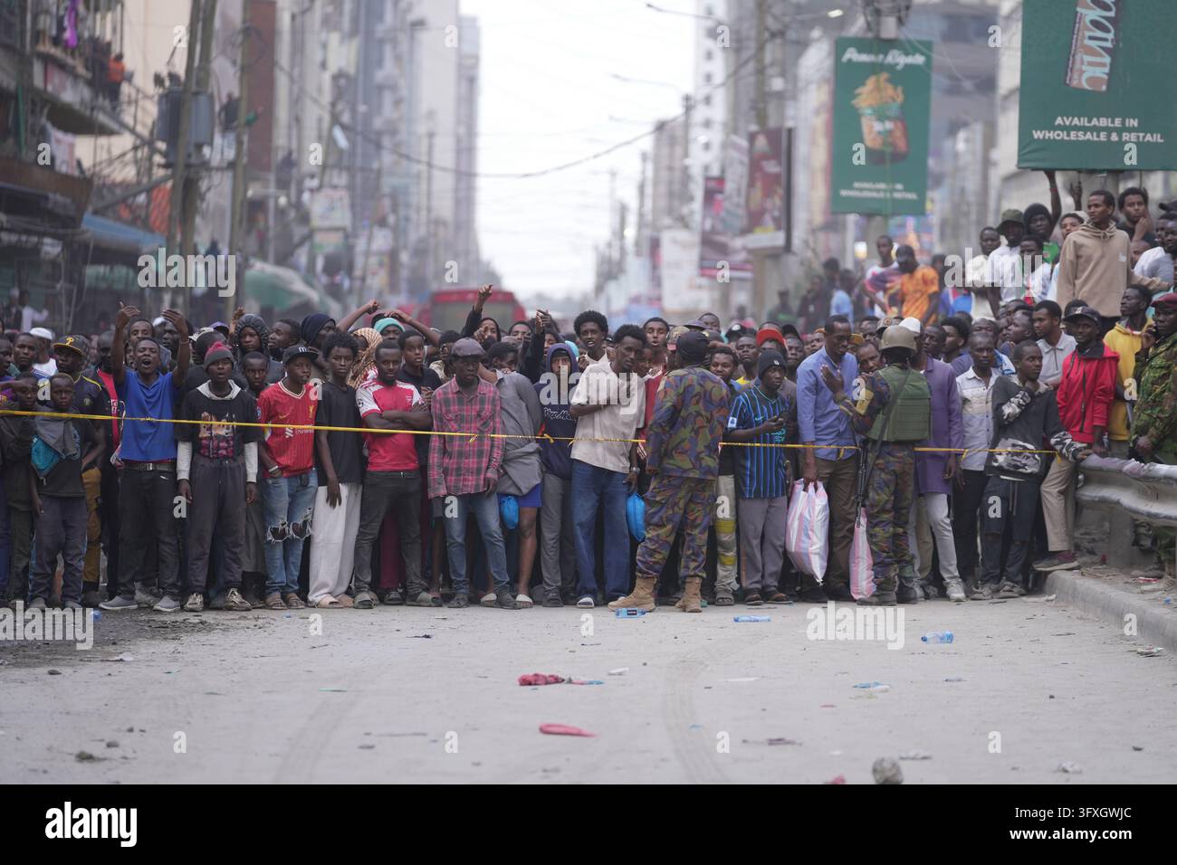 People watch from behind a security cordon after a multi-story building ...