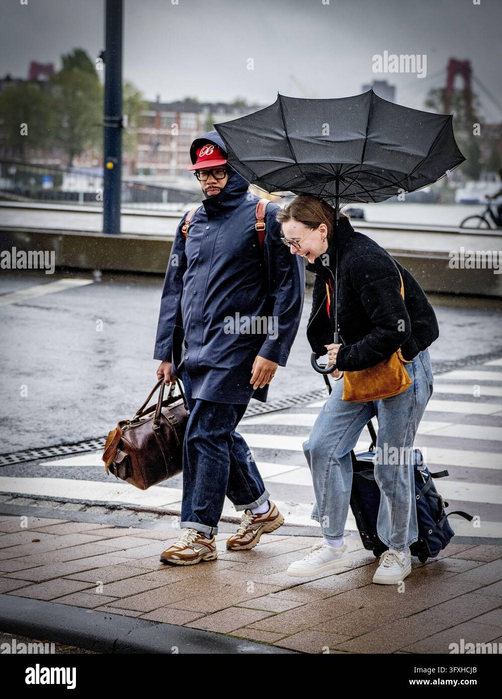 ROTTERDAM - People brave Storm Austen at the Erasmus Bridge. It is ...