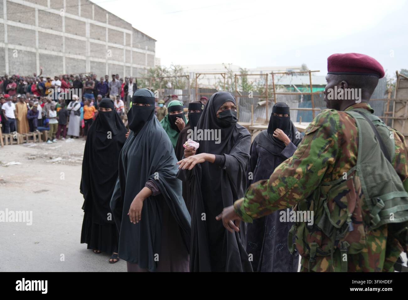 People watch from behind a security cordon after a multi-story building ...