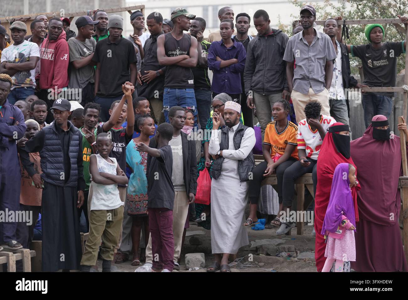 People watch from behind a security cordon after a multi-story building ...