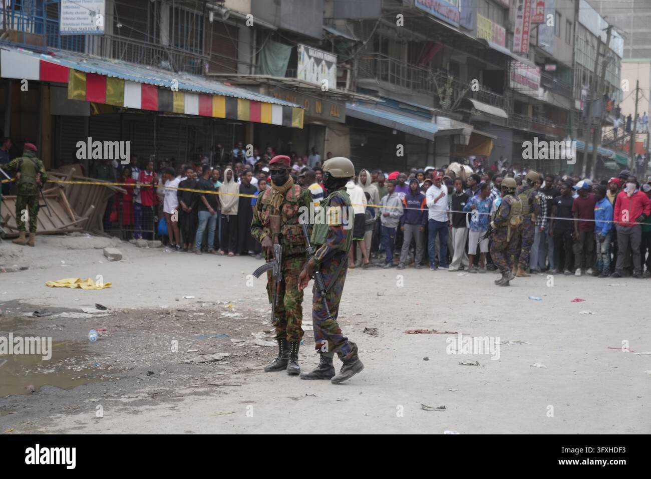 People watch from behind a security cordon after a multi-story building ...