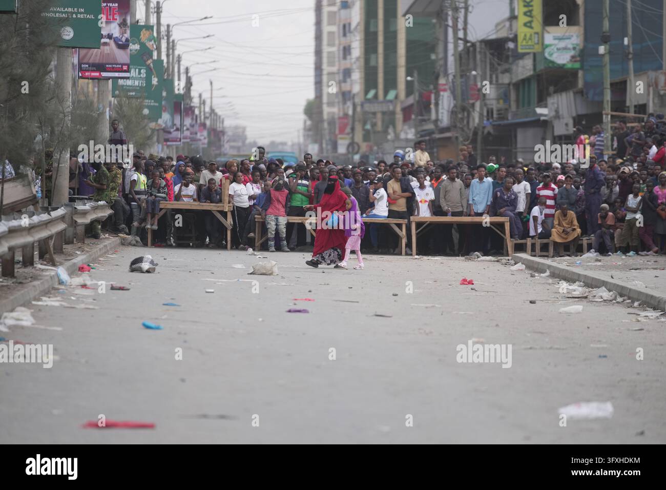 People watch from behind a security cordon after a multi-story building ...