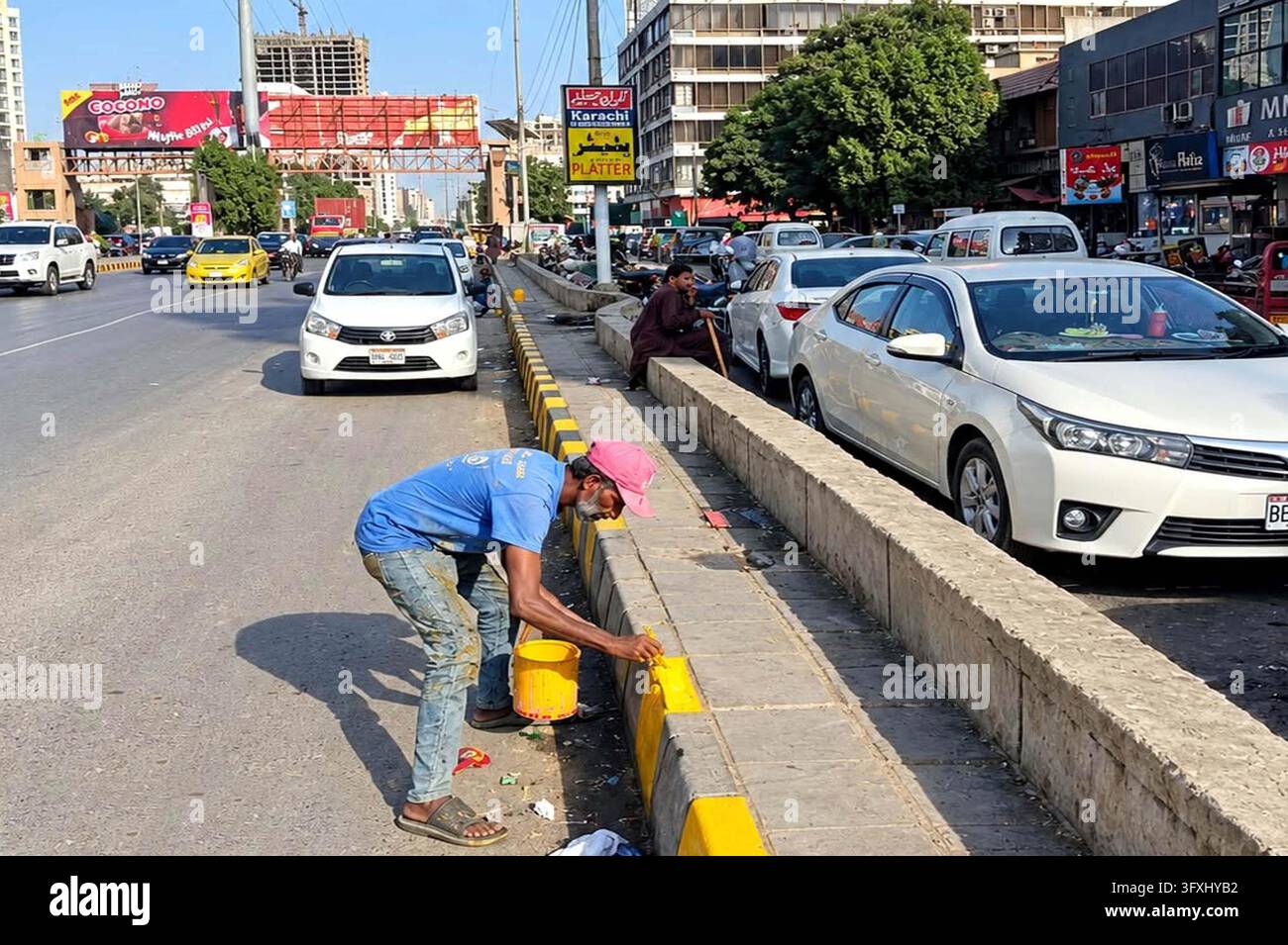 Software Development Images Yellow KARACHI, PAKISTAN - 23-Oct-2026: Labourers in Karachi's Clifton area ...
