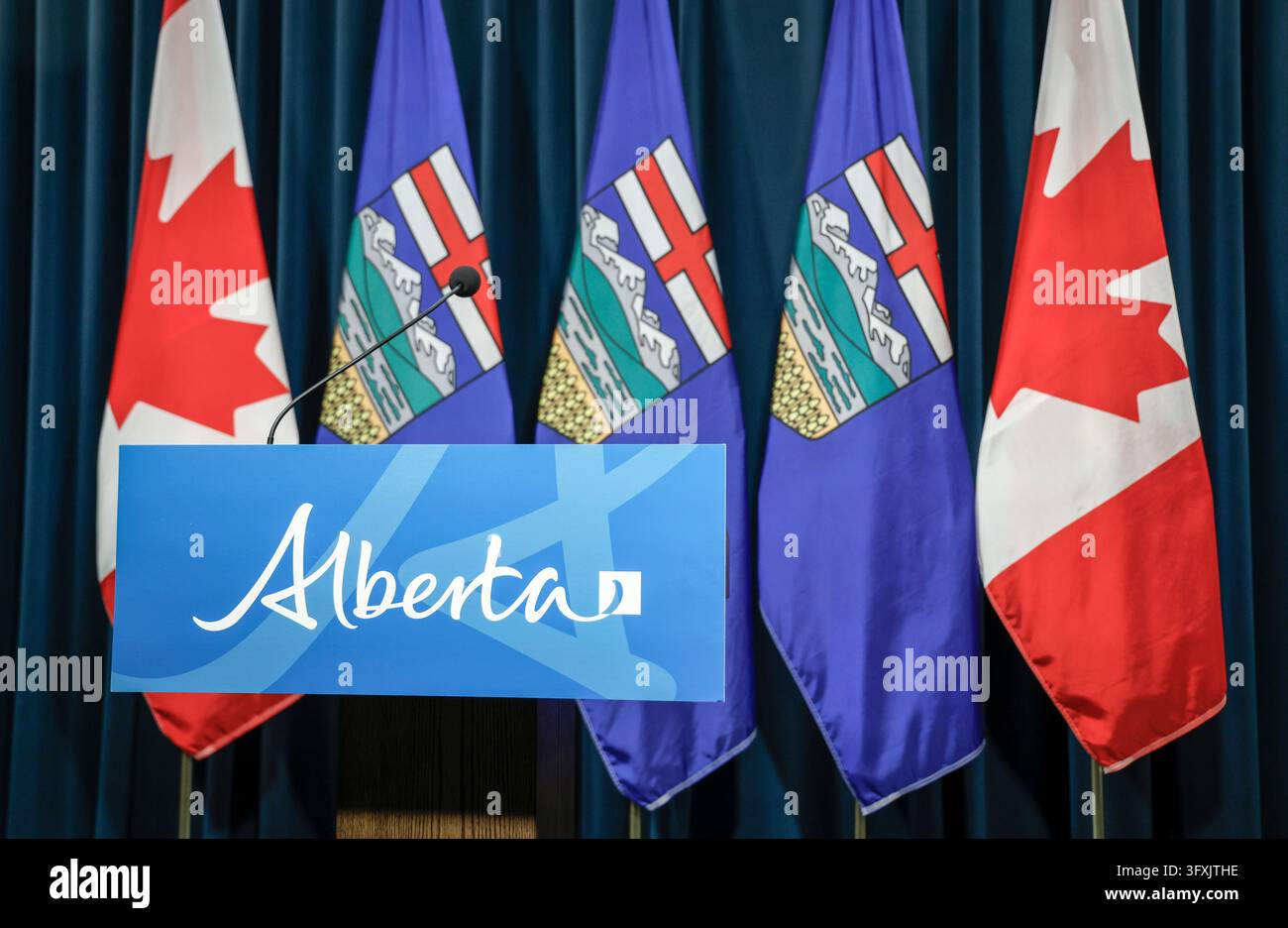 Alberta and Canadian flags are seen behind the podium in a media room ...