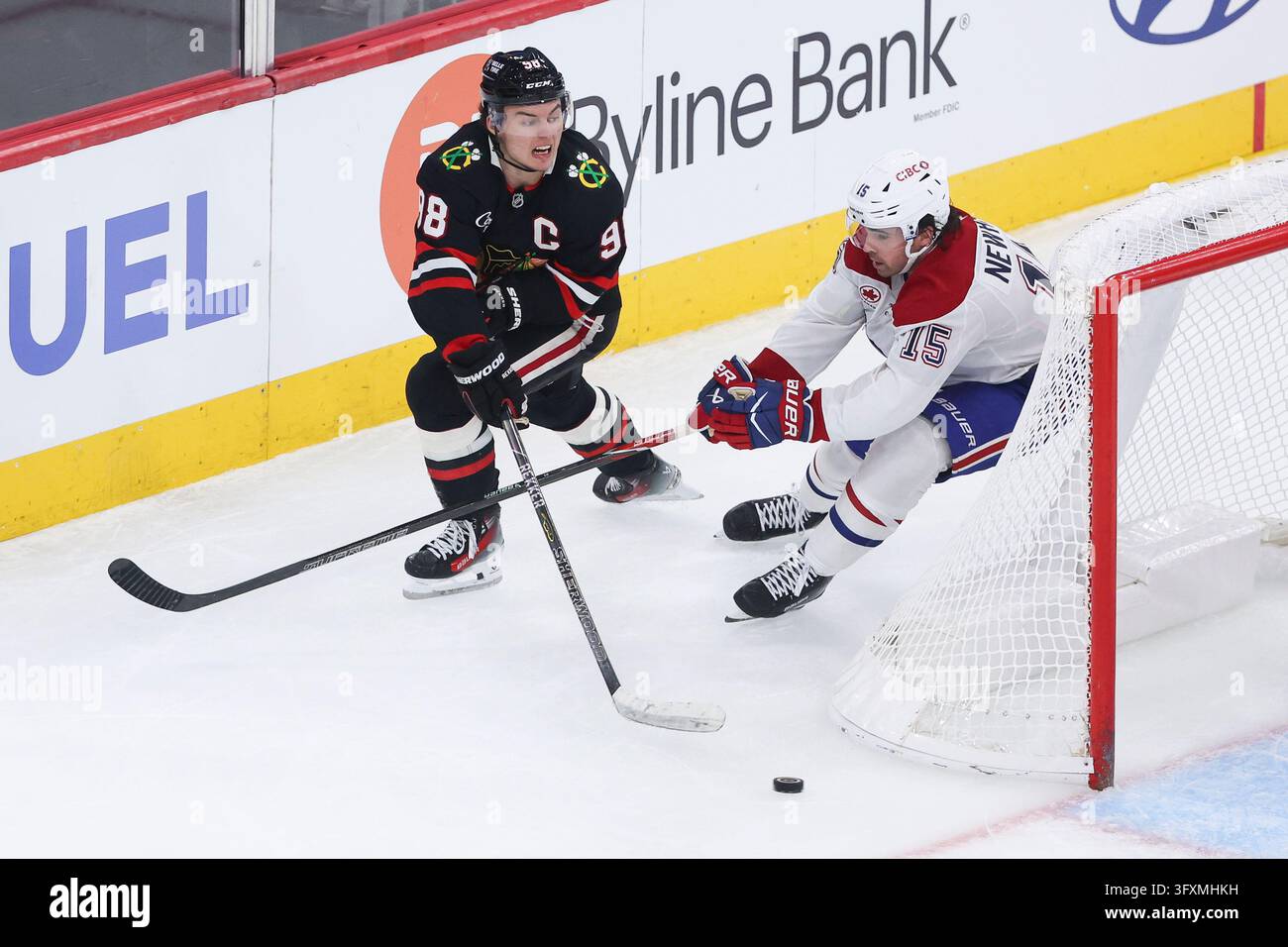 Chicago Blackhawks center Connor Bedard, left, passes the puck against ...