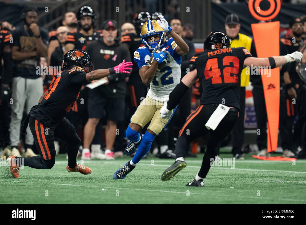 Winnipeg Blue Bombers' Tim White (12) avoids B.C. Lions' Ronald Kent Jr ...