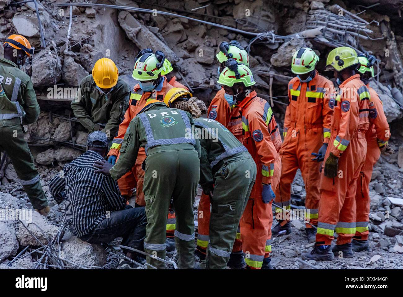 Construction Emergency Rescue Rescue workers comfort a member of the public near the site of a ...