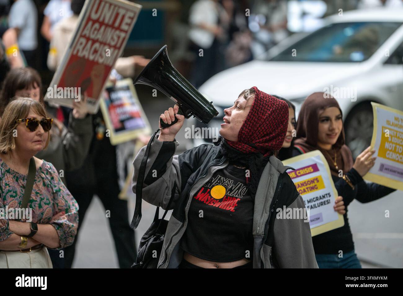 A protester chants with a megaphone during an anti-racism protest at ...