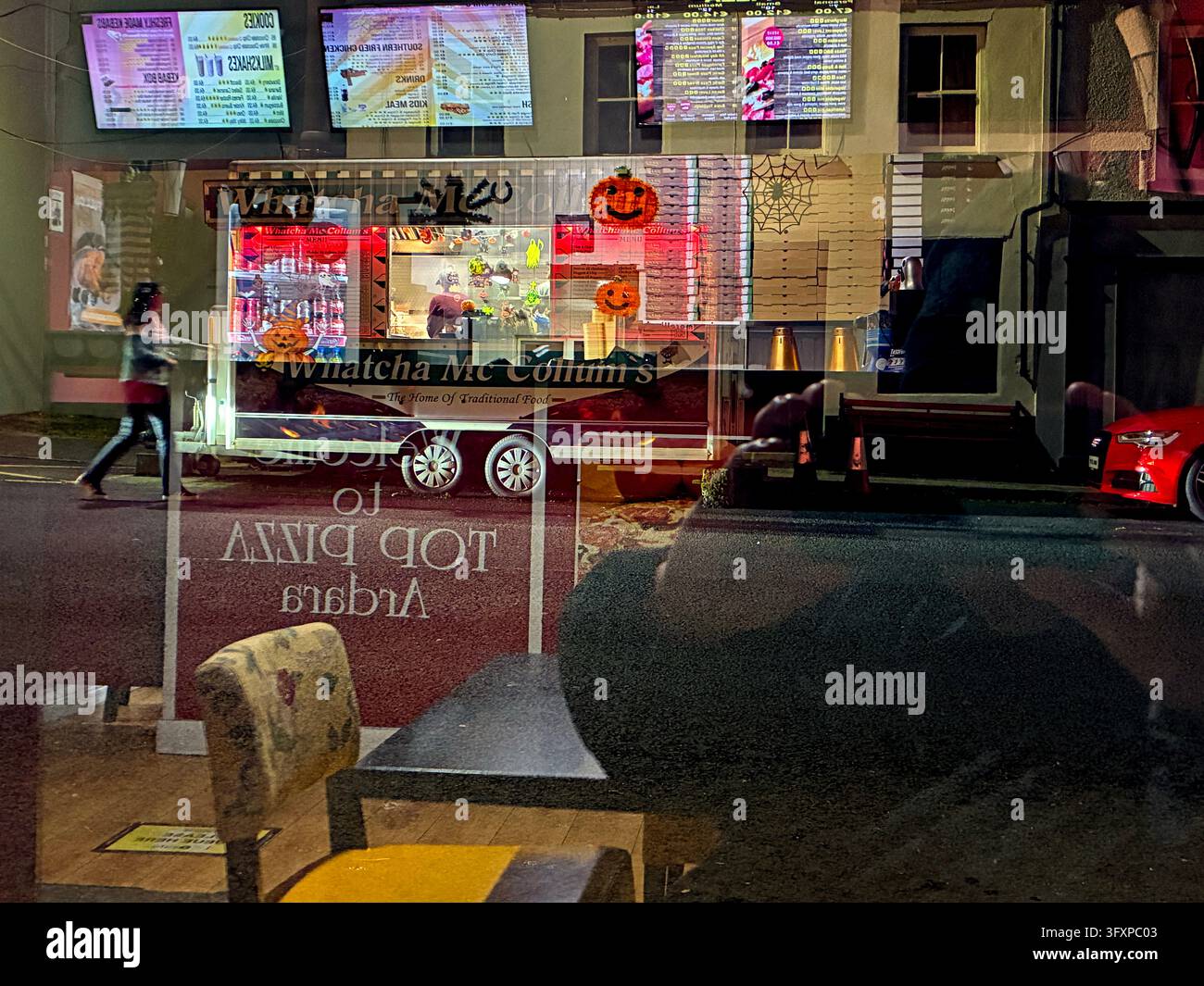 Fast food takeaway outlets reflections at night. - Smartphone Captured Stock Image