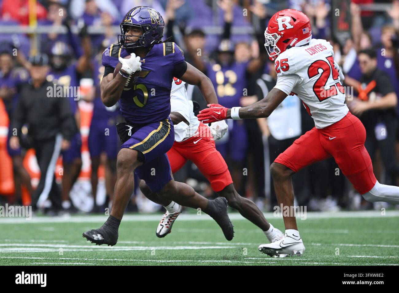 Northwestern running back Caleb Komolafe (5) rushes ahead of Rutgers ...