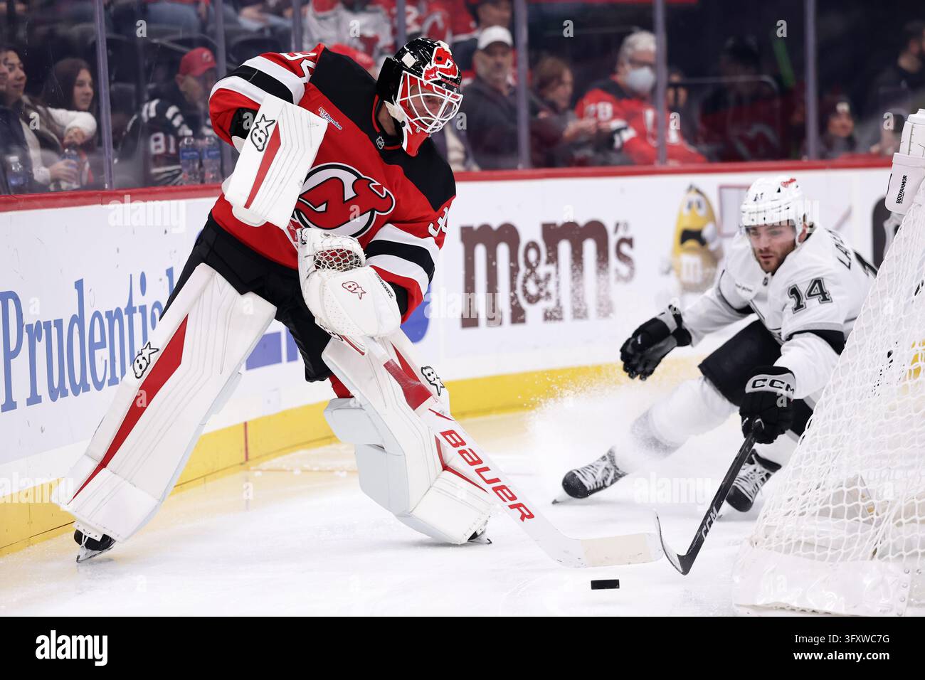 New Jersey Devils goaltender Jake Allen clears the puck away from Los ...