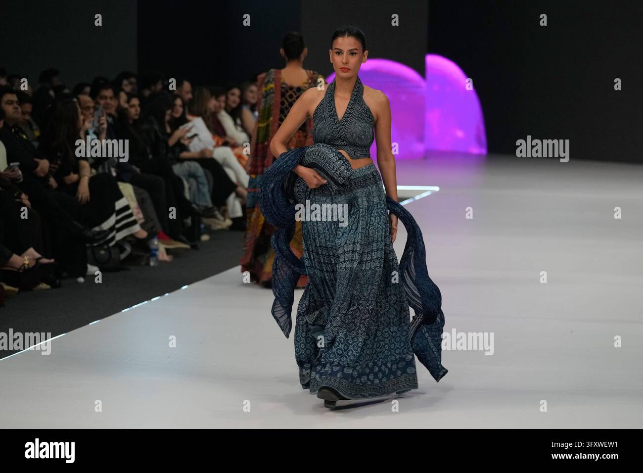 A model presents a creation by designer Yahsir Waheed during Laam ...