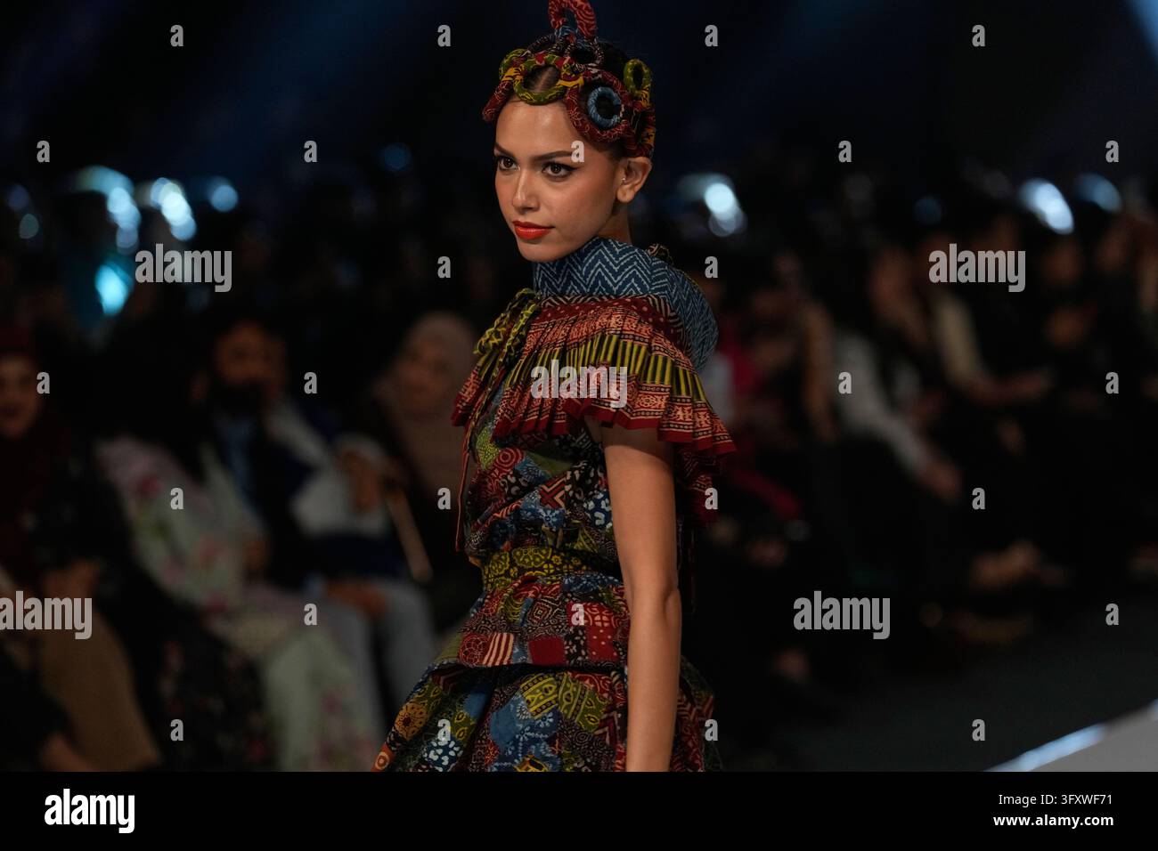 A model presents a creation by designer Yahsir Waheed during Laam ...