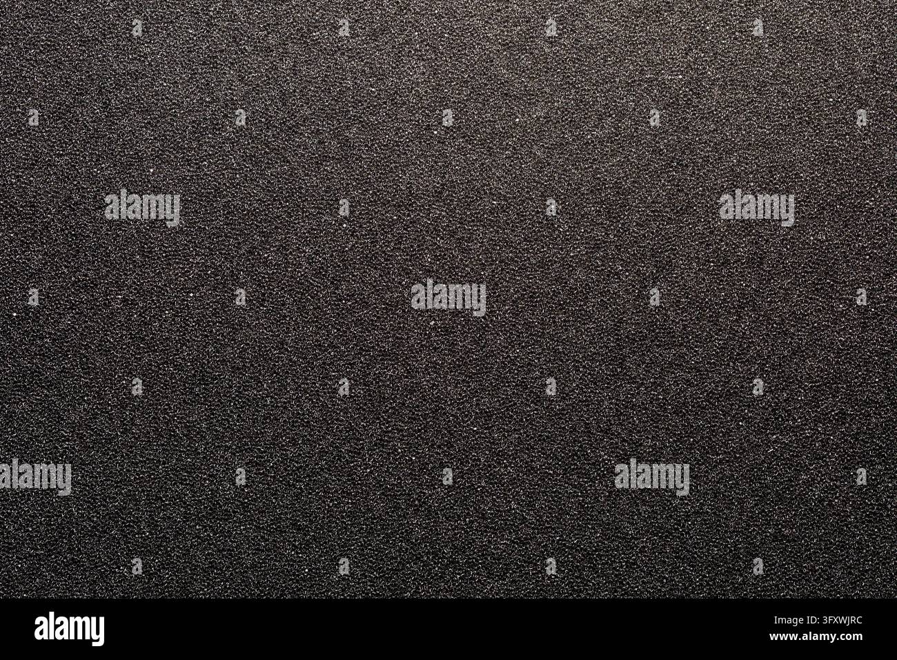 Black packaging foam texture full frame abstract background. Dark grey rough polyurethane foam surface, top view. Background of micro porous spongy ma Stock Photo