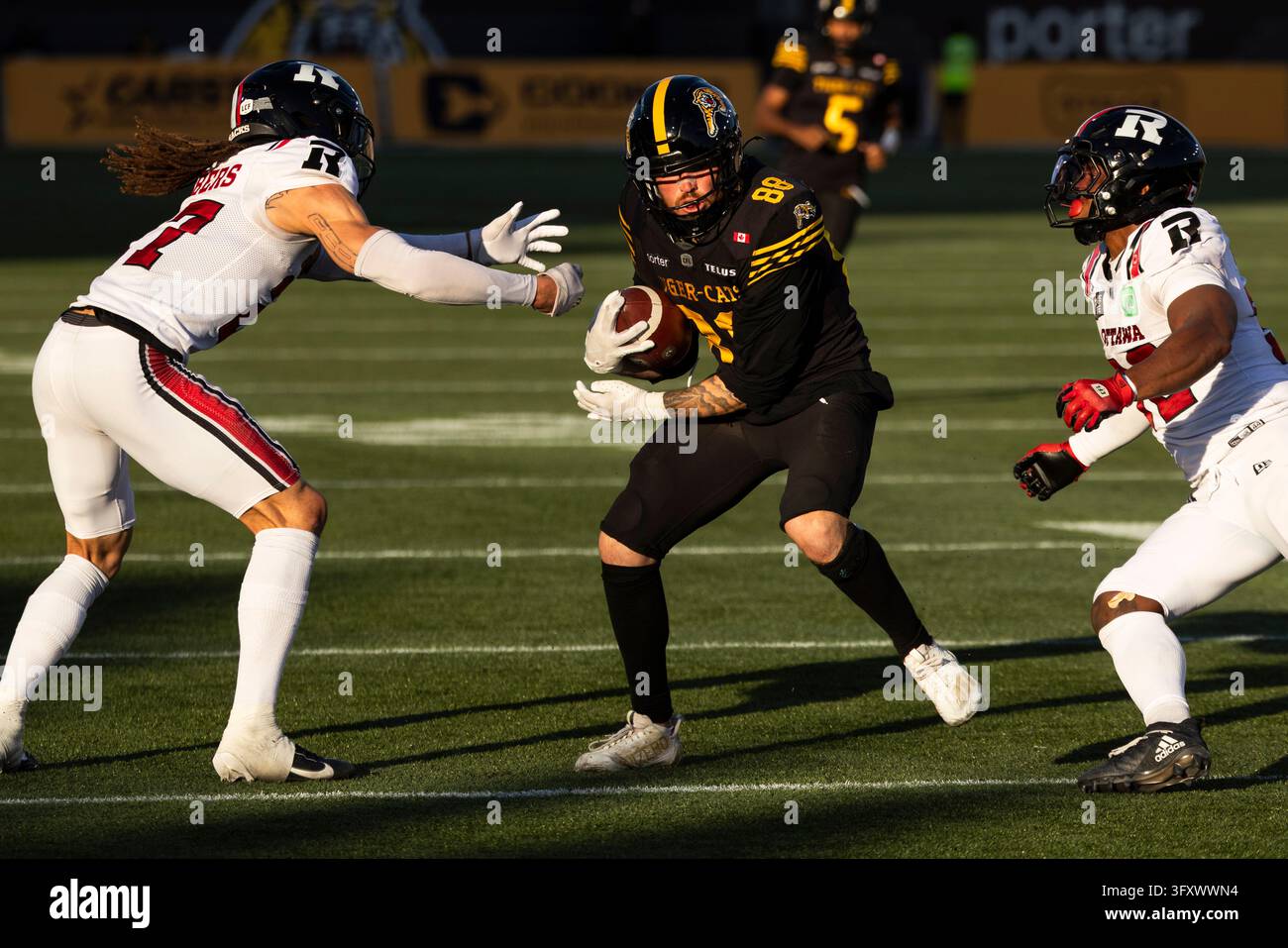 Hamilton Tiger-Cats' Tyler Ternowski (88) runs the ball between Ottawa ...