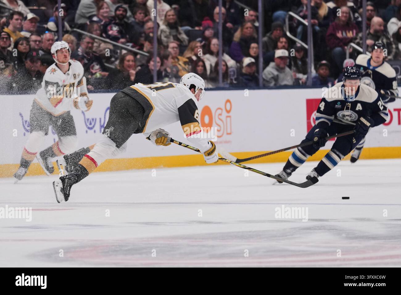 Vegas Golden Knights right wing Mark Stone, center, falls to the ice ...