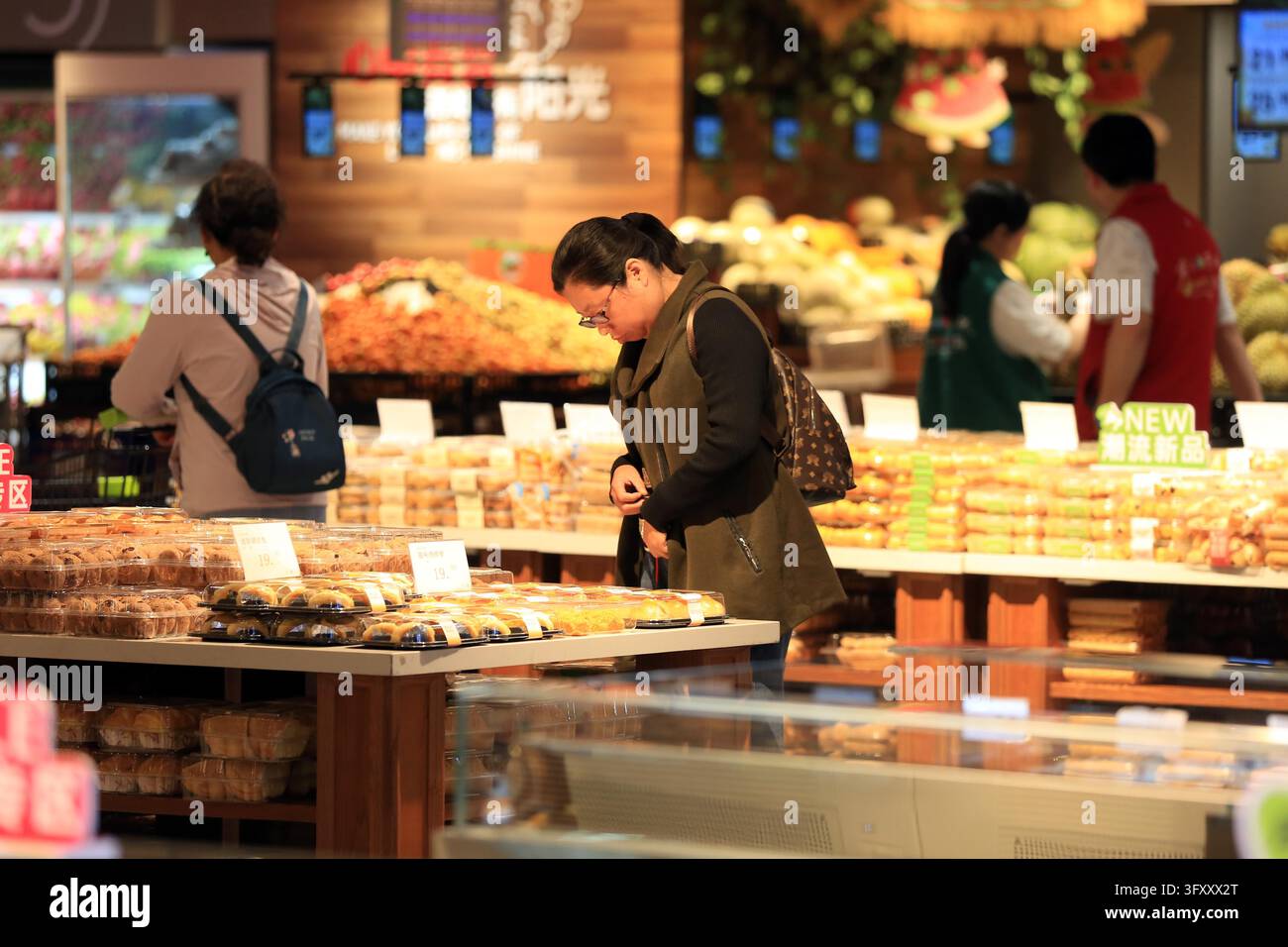 A shopper browses goods at a supermarket in Huai'an, east China's ...