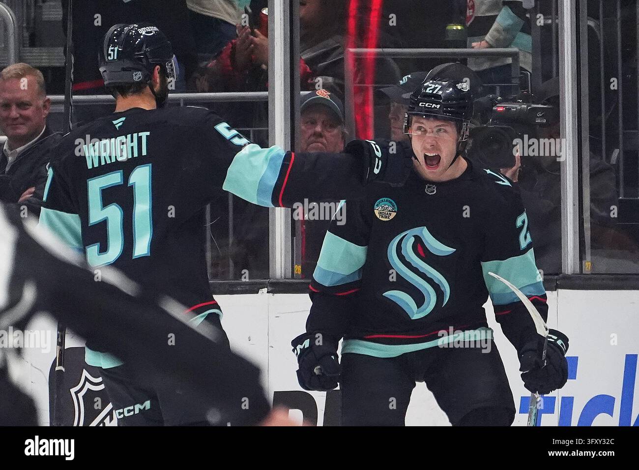 Seattle Kraken center Berkly Catton, right, celebrates scoring a goal ...