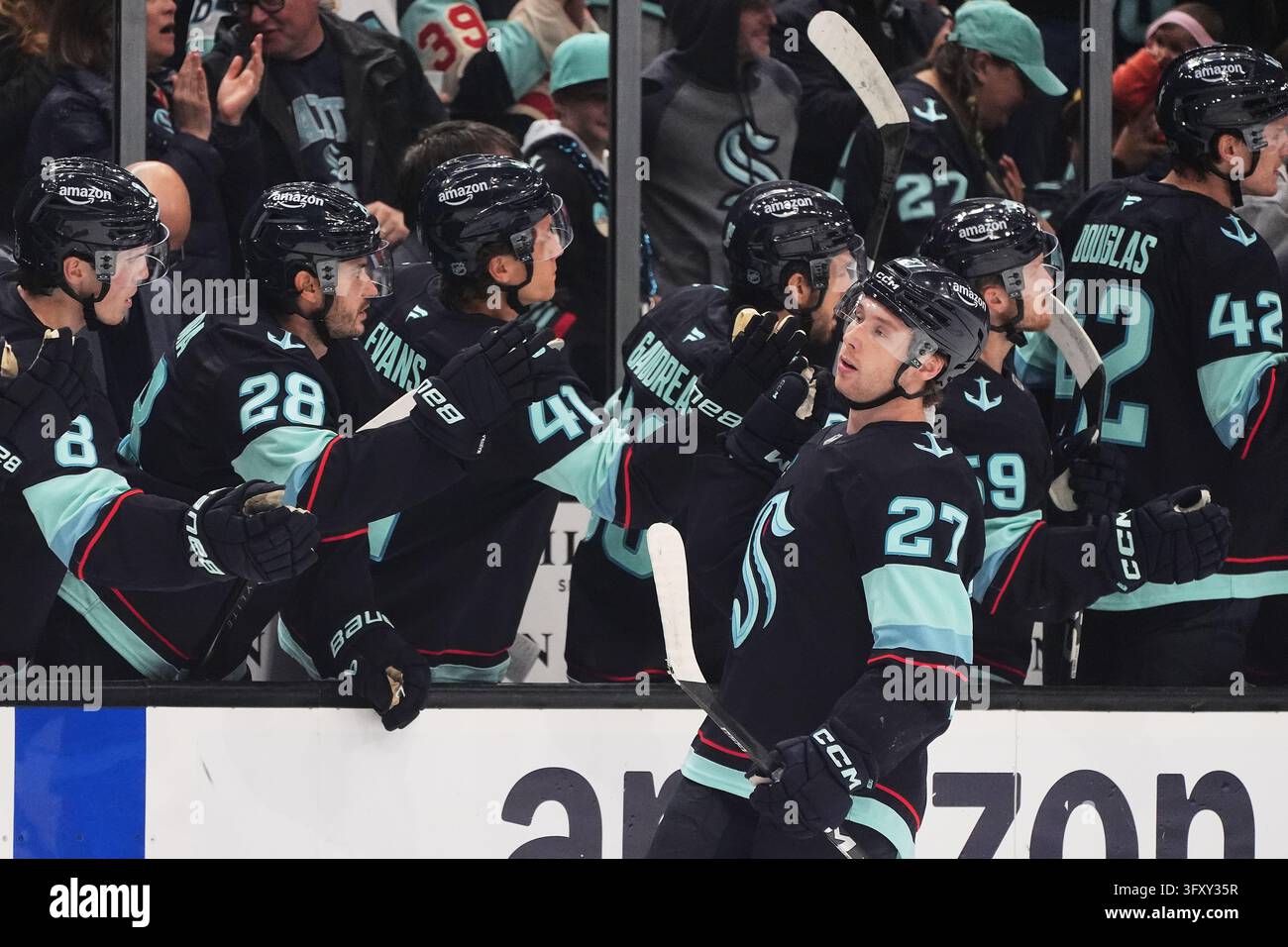 Seattle Kraken center Berkly Catton celebrates with the bench after ...