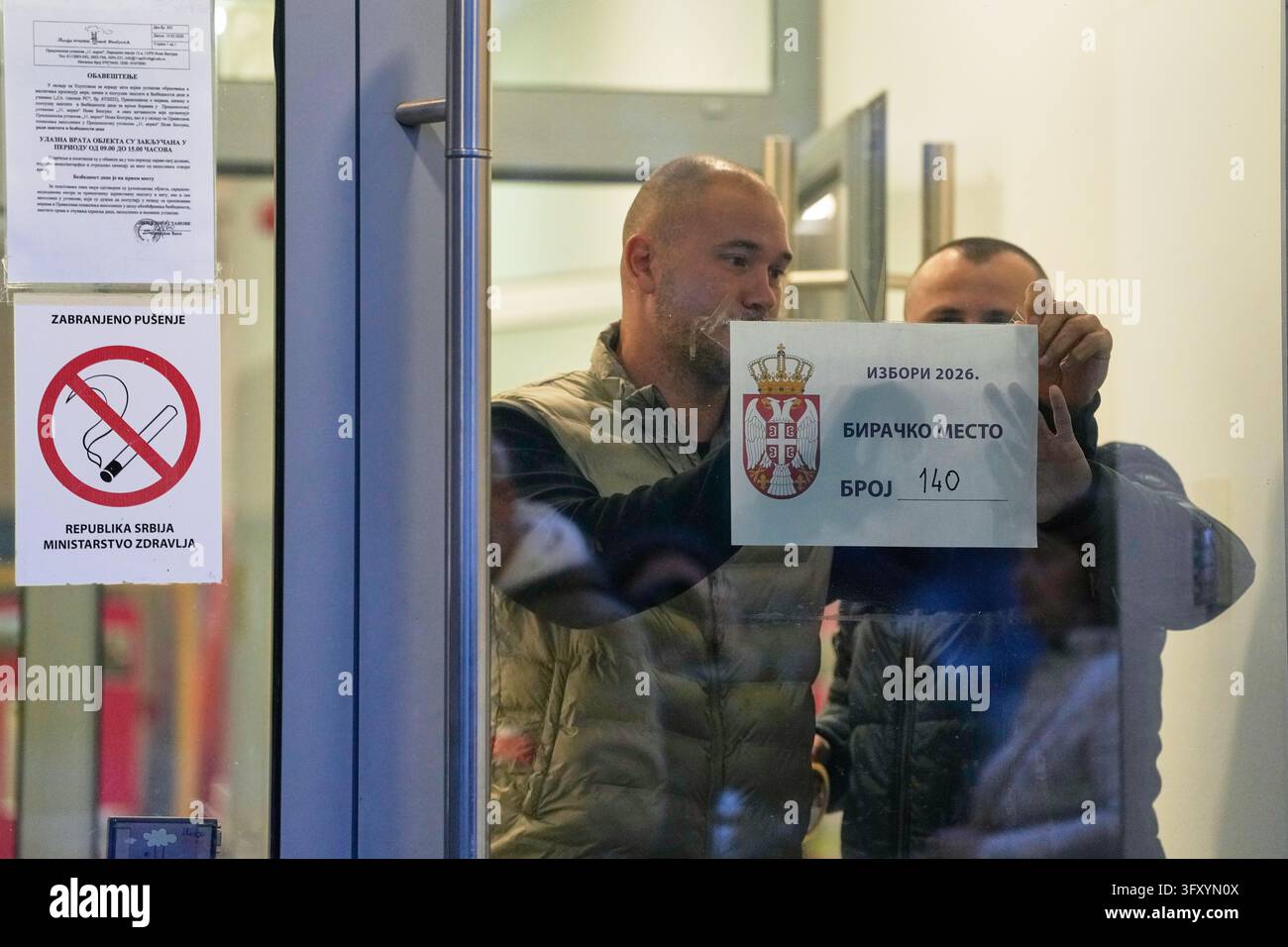 Stick Team Vector Men stick a polling station sign to a door before the start of the ...