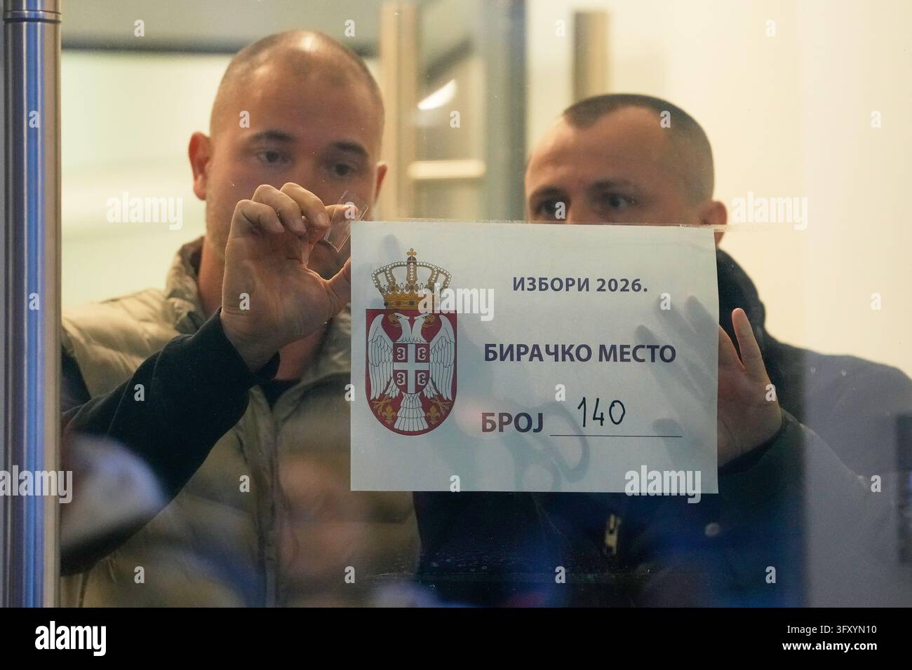 Stick Team Vector Men stick a polling station sign to a door before the start of the ...