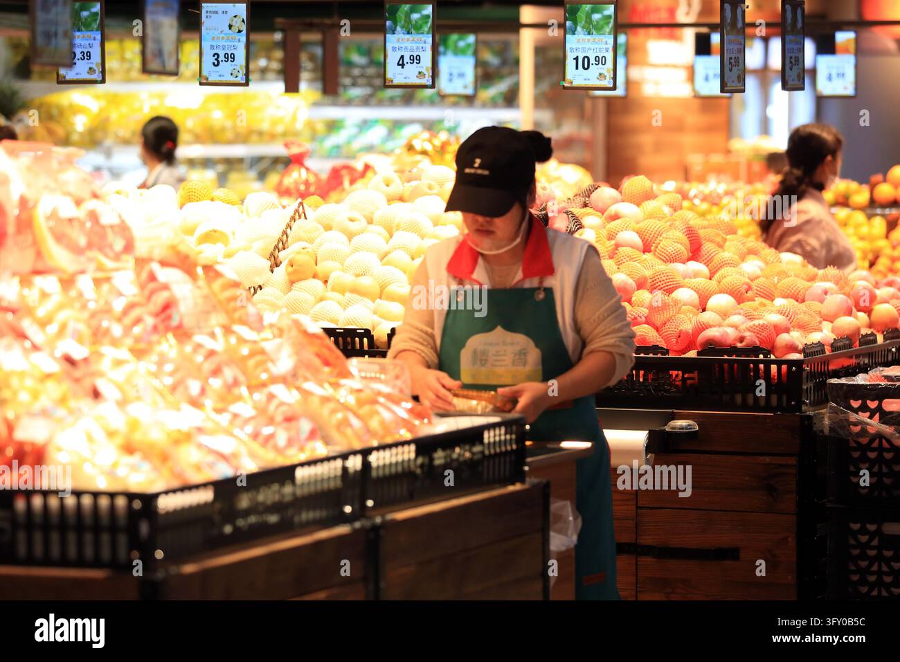 A shopper buys goods at a supermarket in Huai'an, east China's Jiangsu ...